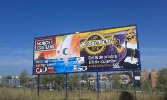 The Department Of Tourism Promotes The Moros y Cristianos' Fiestas And The Oktoberfest In Billboards And Street Advertising Boards All Around Spain